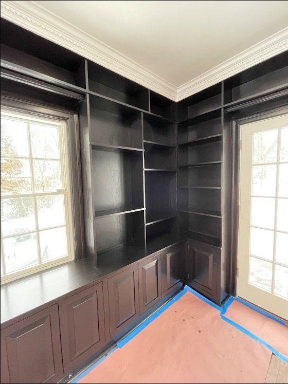 Refinished black built-in cabinets and shelving